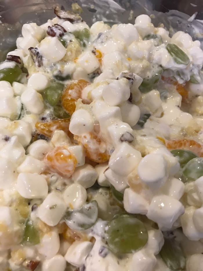 The final step is to stir in sour cream. For this batch I used about 1 1/2 cups. Then cover the salad and let it sit in the fridge overnight. This lets the marshmallows absorb the fruit juices - hence the name.