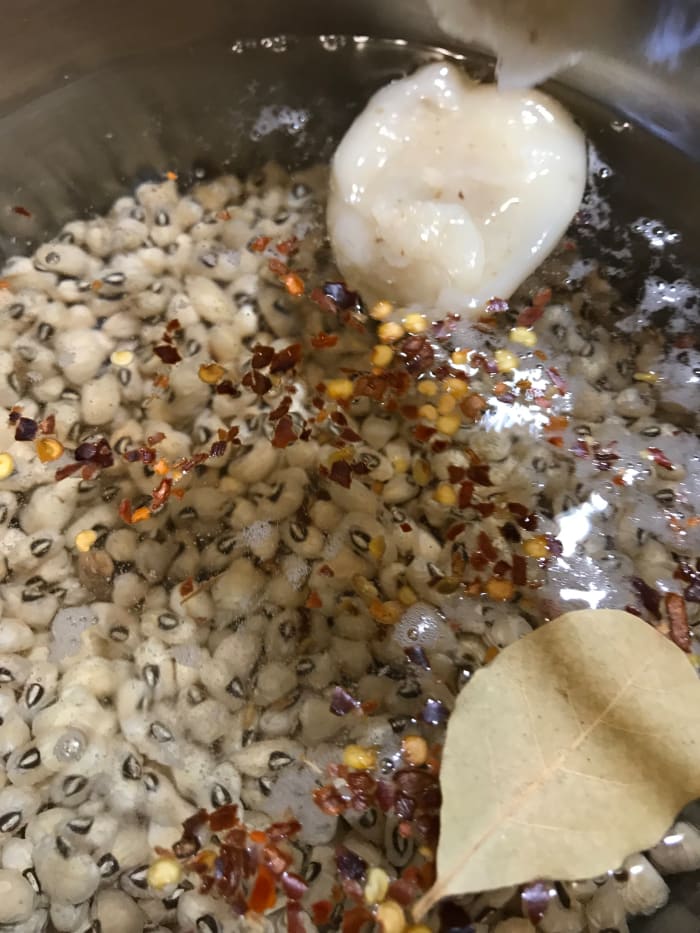Add the remaining seasonings and bring to a simmer. You can skip the bacon drippings to have a vegan version, but you'll need to increase the salt and pepper, and maybe add a drop of liquid smoke. The bacon grease is the traditional method.