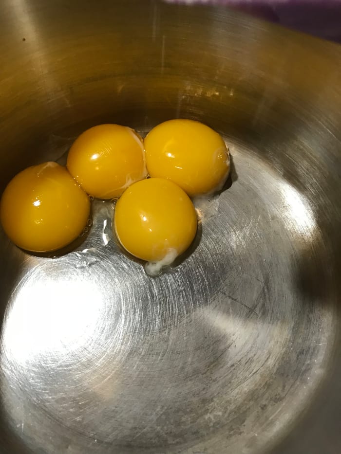 Place the yolks in a medium sized saucepan. You'll be whisking in the sugar. You can whisk those together before turning on the heat.