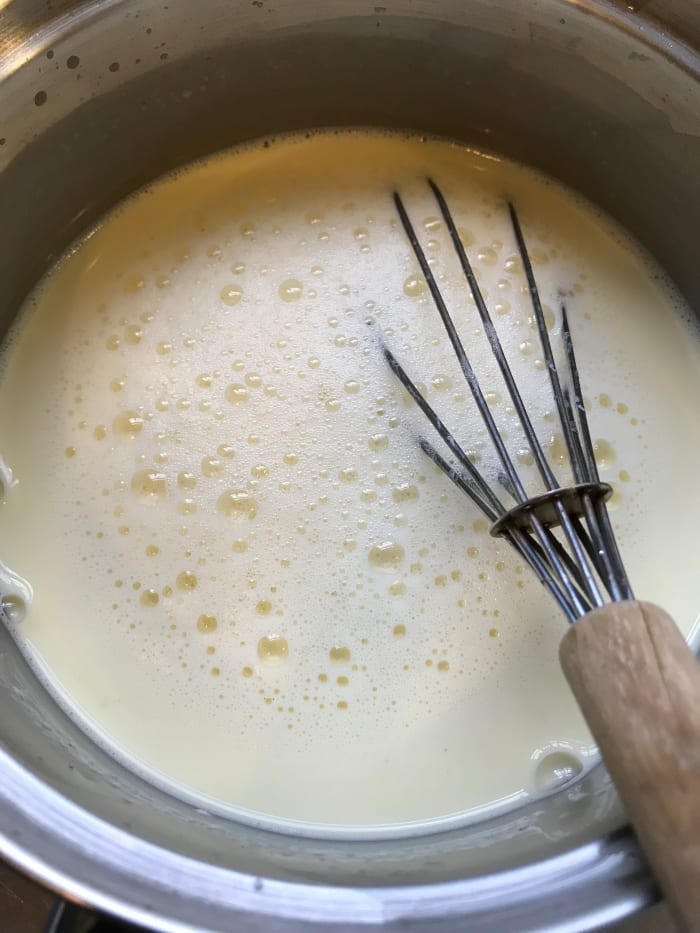 The fastest way to chill is to set the pan in a sink of cold or iced water, and whisk for a few minutes. The temperature will come right down. Or just stick it in the fridge for a few hours.
