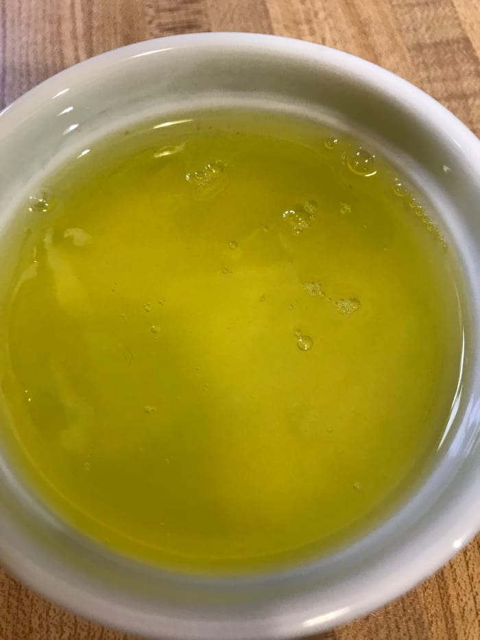 Separate four eggs, and place the whites in the bowl of a mixer. These will make the eggnog light and fluffy. The yolks will be cooked with sugar, milk and cream to form the base of the eggnog.