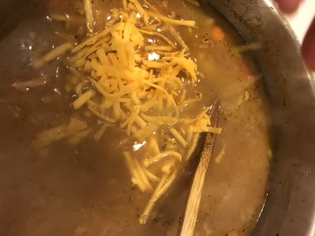 Stir in the slurry and stir well, bringing the pot back to a bare simmer. Drop the cheese in by the handful, stirring between additions, until all the cheese is added.