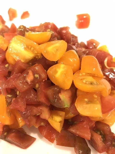 I used these colorful miniature heritage tomatoes, but it doesn't matter what you use. Just grab whatever is available and dice them up. Throw them in right after the seasonings and let them simmer.