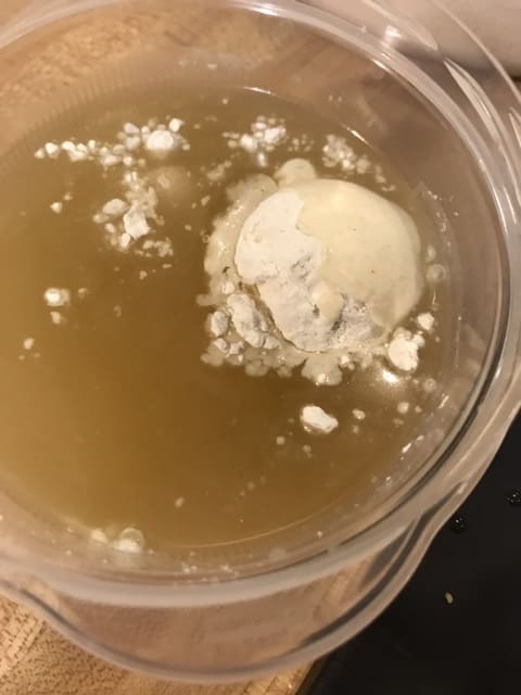 A slurry is just flour mixed into cold liquid - this lets you add it to the pot without getting lumps. Whisk it well first, to ensure the flour is fully incorporated.