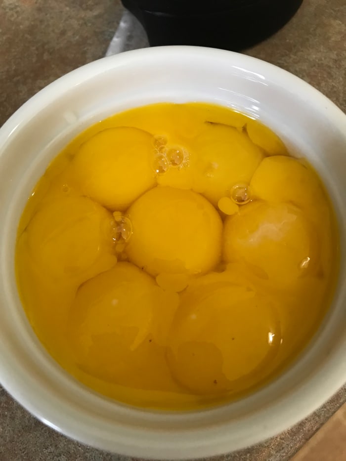 8 egg yolks are whisked into the hot cream base. They bring richness and depth of flavor and serve to thicken the gorgeous custard.