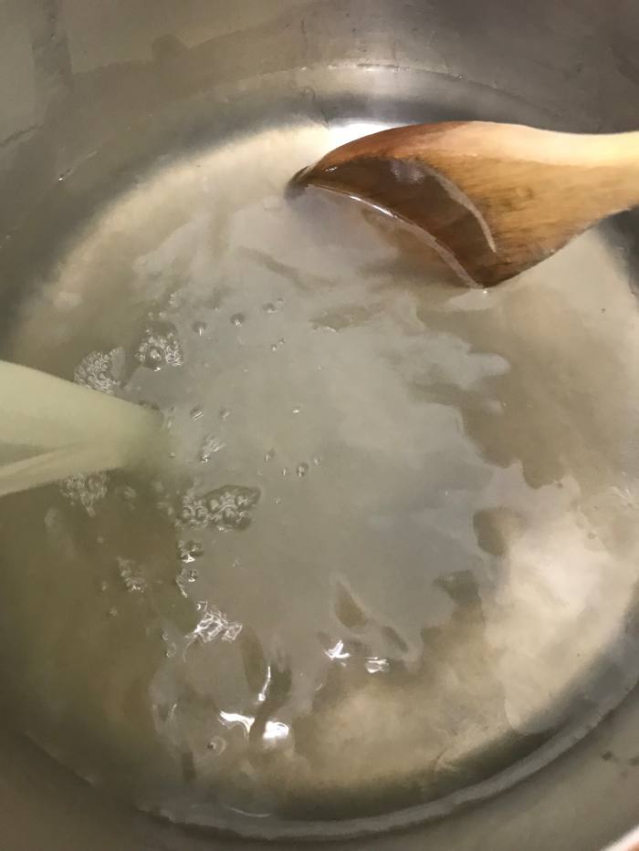 Remove the simple syrup from the heat, let it cool a bit, and add the fresh lemon juice. If you add it too hot, you'll lose some of the fresh, tart 'zing' of the lemon juice. Just over room temperature is fine - do it then.