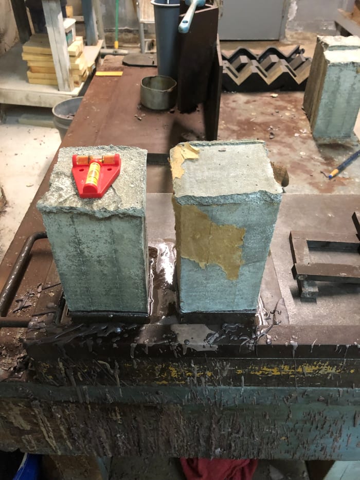 With this alignment device, both bubbles have to be within the black lines for the grout prism to be centered on a vertical axis.