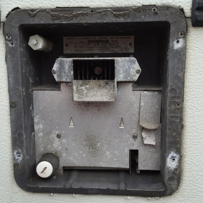 This shows what is immediately behind the flue cowl. At the bottom left corner you can see the drain plug that has to be undone.