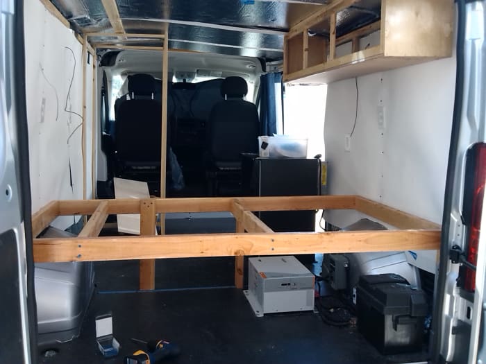 Bed frame with electrical equipment under the foot and storage under the head of the bed.