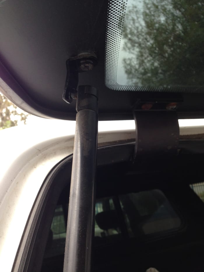 Whether your rear door is all-glass or has an aluminum frame, the prop is held on a small ball stud. It literally pops in place.