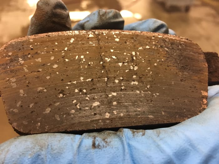 This brake pad was overheated and has a crack down the middle. The pad material was so brittle it was causing a grinding noise.