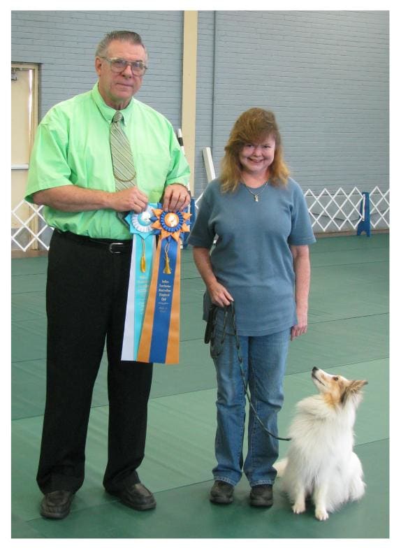 Jericho, the judge and his owner with his "High in Trial" and "High in Trial Other Breed" ribbons won at an ASCA obedience trial. Notice Jericho's strict attention to his handler. He's watching for more commands!!!