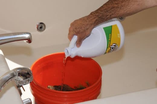 Use approximately 1/2 cup of bleach to your 5 gallons of water. Try less and determine if it works as well.