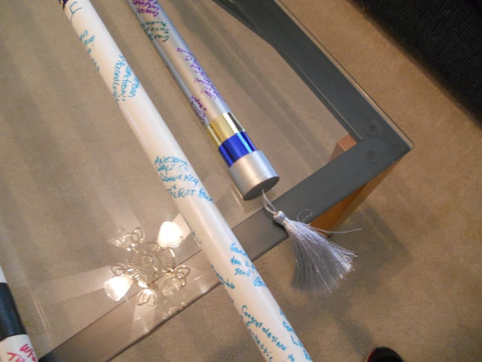 Example of a tasseled and painted MACH bar. The matte silver paint allows for the congratulatory notes to be easily seen.