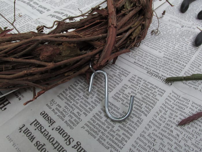 Metal hook that came already inserted into the grapevine. I could then attach my 'S' hook to that for easy hanging.