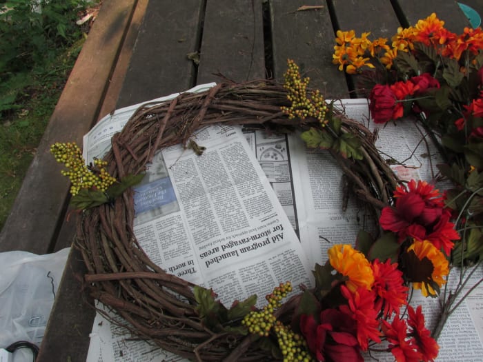 Begin by adding flowers starting with your focal point. I had some interesting green berry stems that I used for dividing my wreath into thirds.