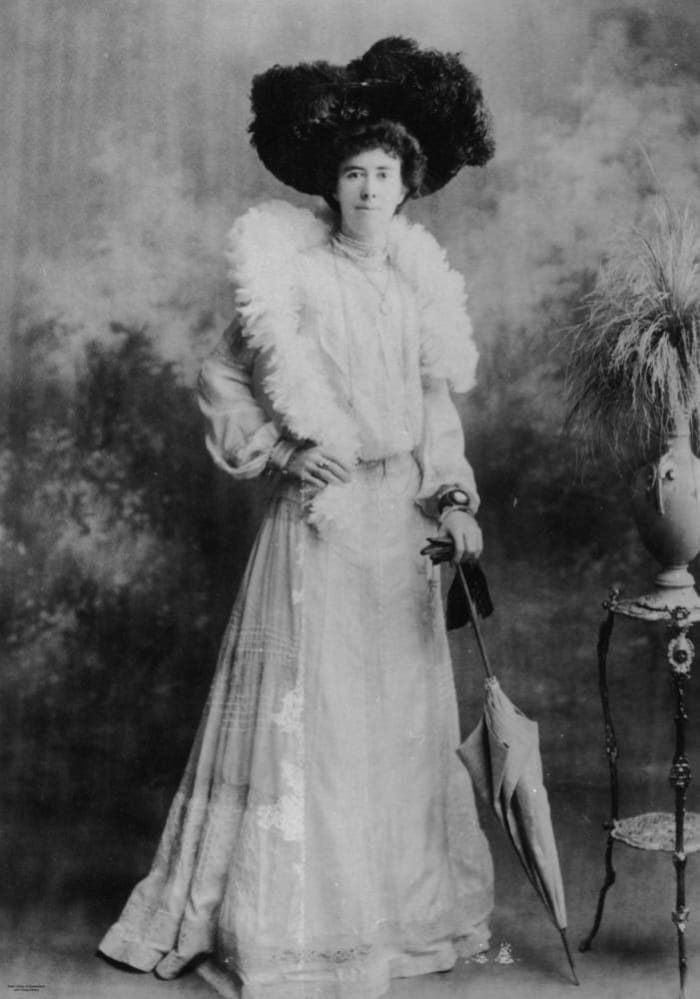 How many birds is this woman wearing? Feathered hats and boas were popular during past eras. This photo was from about 1900.
