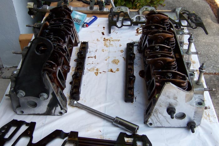 The heads. Don't forget to reinstall the plastic lifter guides. The coil pack installation post can be seen on the head to the right.