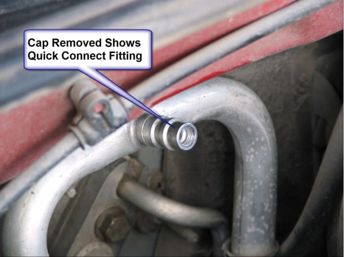 Cap of low pressure service port has been removed, revealing threads for the quick connect hose.