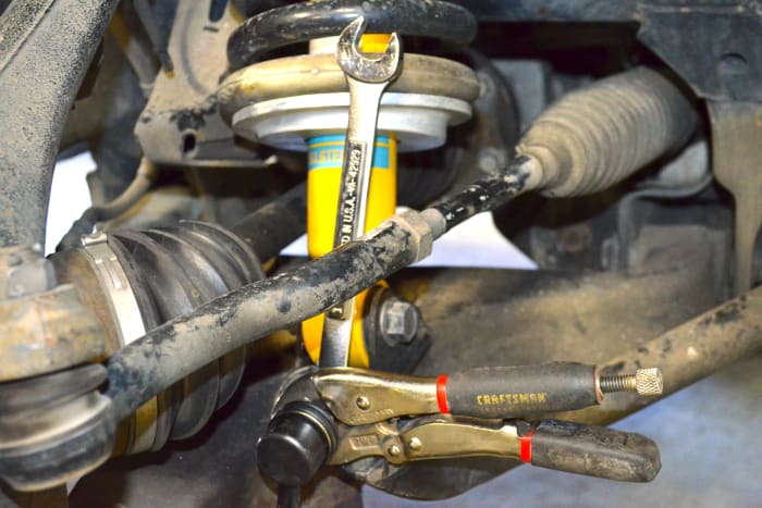 Tighten the nuts down on the sway bar link bolts. Use the 17mm wrench and vise grips to ensure tightness. Nissan recommends 42 ft- lb. of torque on each nut.