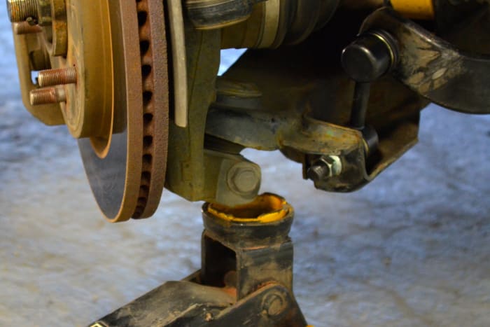 Insert the new sway bar link, being careful not to ding the threads. A jack may need to be used to raise the lower control arm into position. The bolts of the links should slide right in.