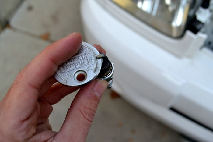 Reading the gap measurement on the plug. The gap should be .032 inches. Check your owners manual for your exact gap spec.
