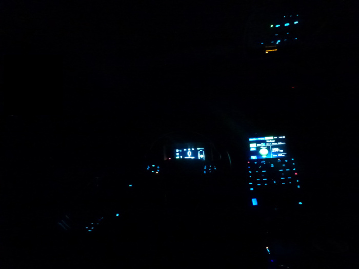 The Chevy volt interior, at night. Taken from the back seat, looking forward through the drivers area.