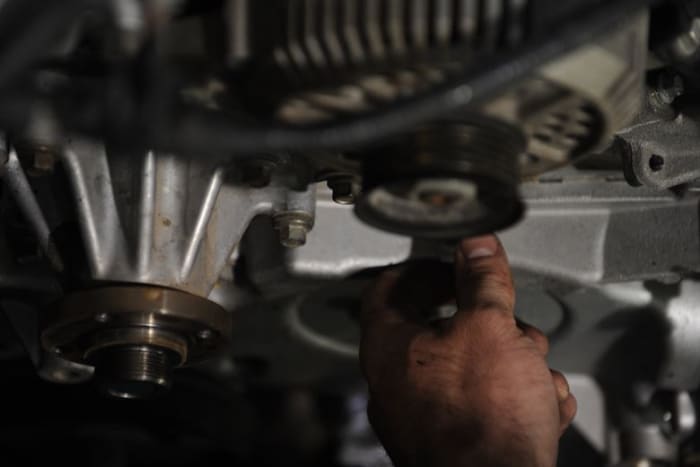 You may need to remove one or more accessories to detach the timing belt cover.
