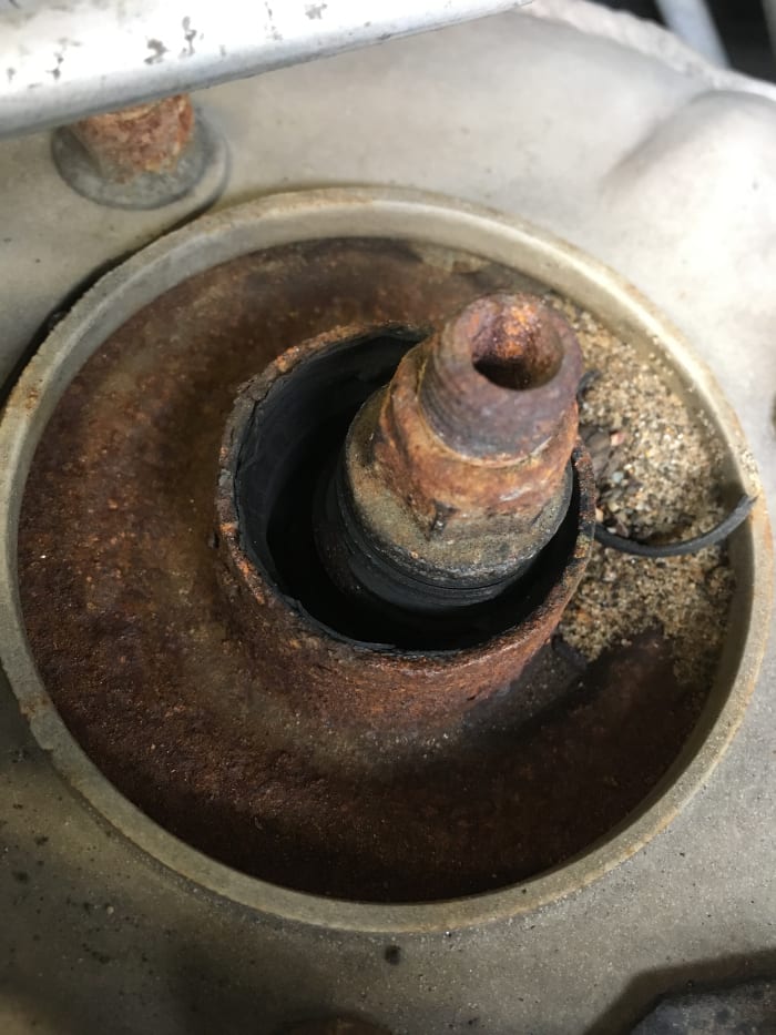 This is a strut mount that is missing the rubber bushings, it was hitting metal to metal on every bump.