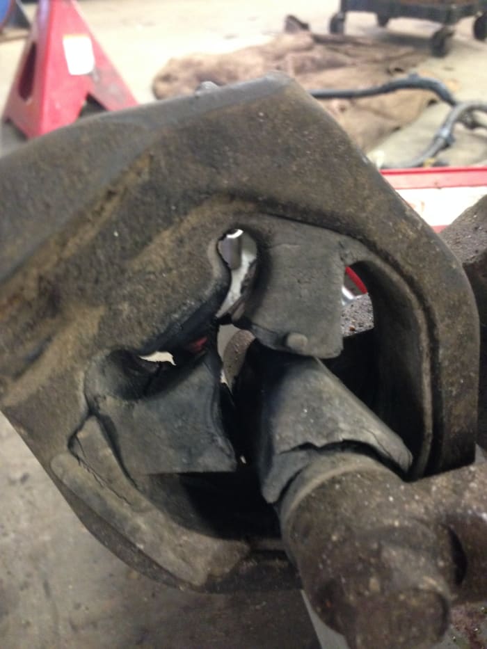 Here is a transmission mount that has failed. Part of the mount was hitting the frame of the vehicle and was making a clunking noise on every bump and start off.