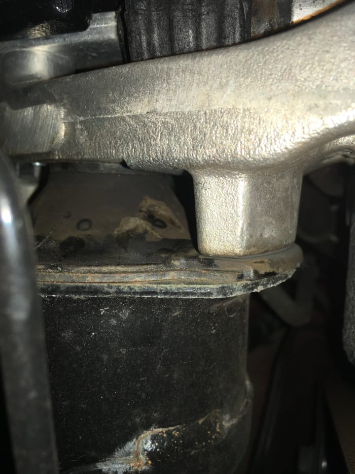 This is a motor mount that has collapsed internally. The mount holder (top) was hitting metal to metal every time the motor moved, making a loud knocking noise.