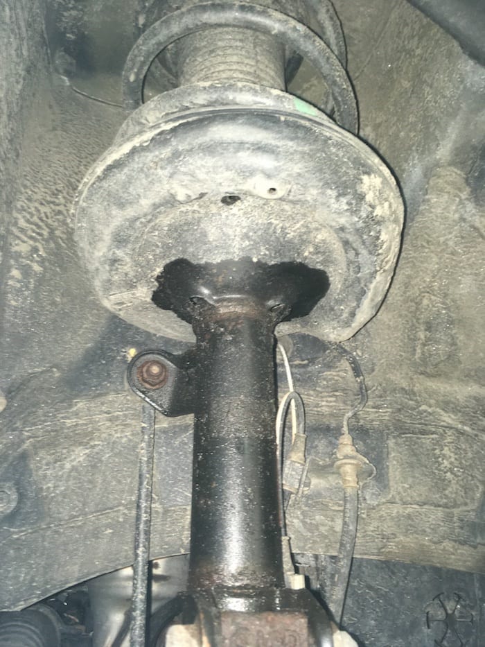 Oil leaking from the strut. If all the oil leaks out, this strut will start to make a knocking noise over bumps and cause excessive tire chop.