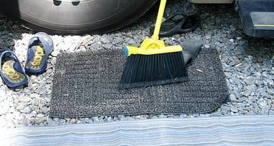Every camper should have a small mud rug to place at the bottom step of their RV door. By using one of these, there will be a lot less dirt, sand, and gravel tracked into the cabin. They only cost a couple of bucks and are worth every penny.