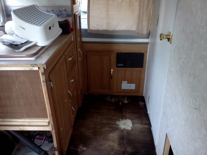 Flooring removed rear of camper. Bath is to the right. I am going to leave that floor alone as it seems pretty solid.