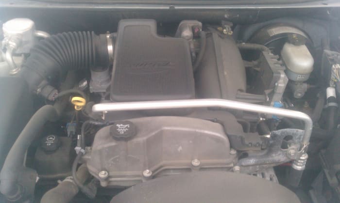 Under the hood of the Chevy. The air filter is to the left, just off picture connected to the plastic tube. The throttle body is in the upper center, behind the big plastic housing.
