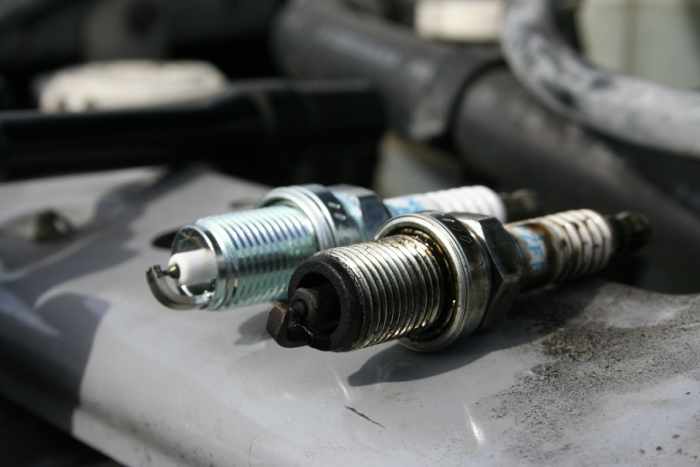 A new spark plug versus an old spark plug. Replace your plugs about every 100,000 miles to keep your vehicle running smooth.