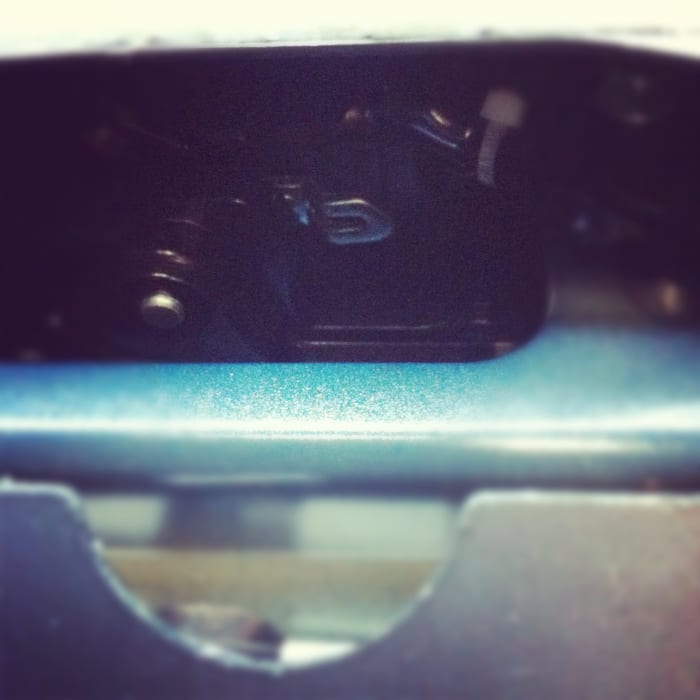 Pull that silver, backward c-shaped lever toward you. The trunk door will pop open.