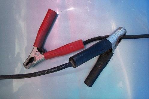Clip either the positive or the negative clamp to the others wire. This way there are no accidents.