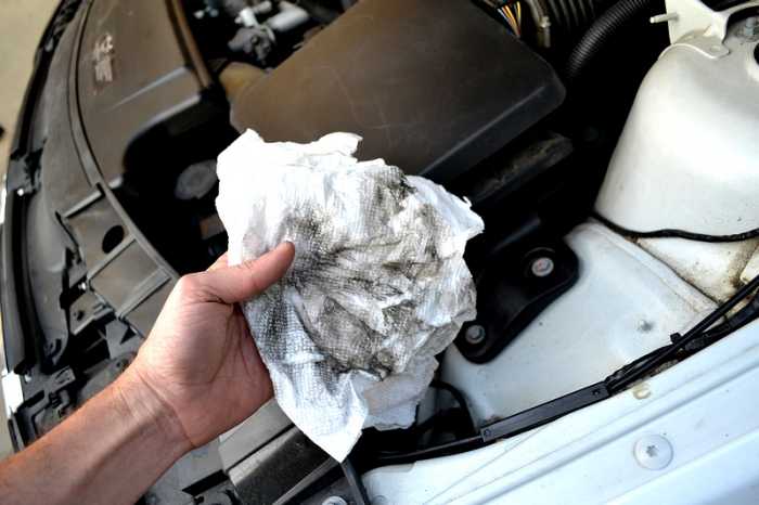 Look at all this dirt that was in the bottom of the air box. Once cleaned out, install the new air filter back into the air box and latch each of the clips back again to close.