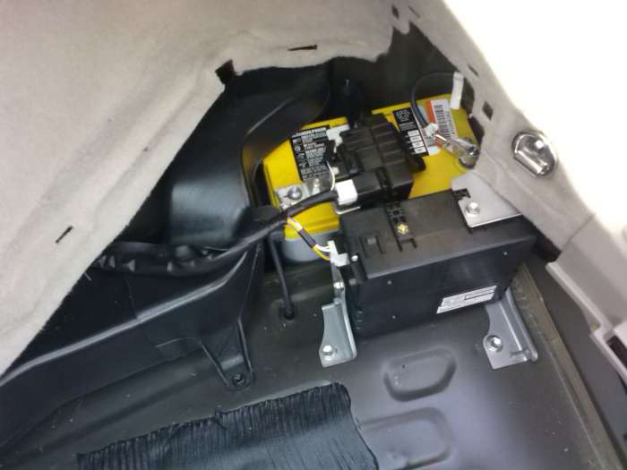 The Prius' battery lives here, hidden under a panel in the rear, passenger-side corner of the hatch.