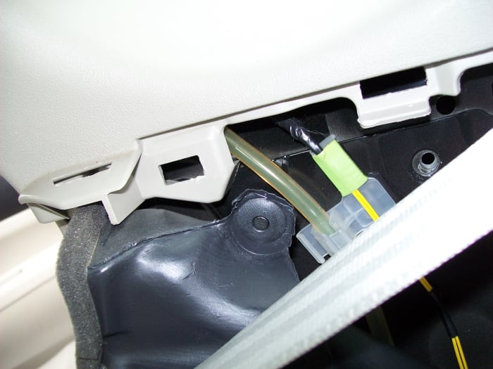Gently pull on the ducting assembly to pop out this push pin and remove the intake duct to gain access to one of three bolts securing the fan.