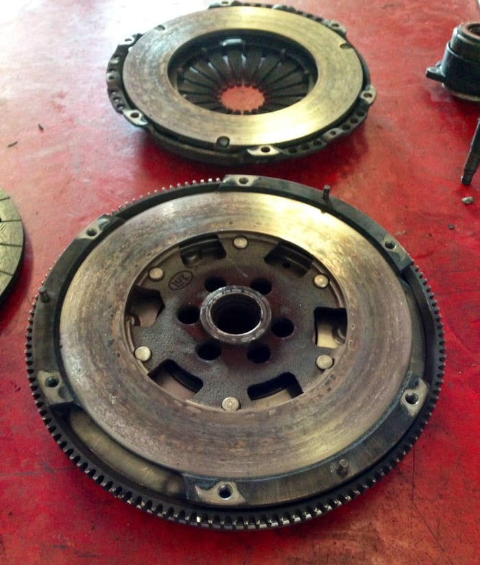 This 13-year-old Dual Mass Flywheel had 133,000 miles too (but was laid to rest when replacing an original clutch). Erratic idles, audible "rattling," and knocking when pressing or lifting the gas pedal can indicate a worn DMF.