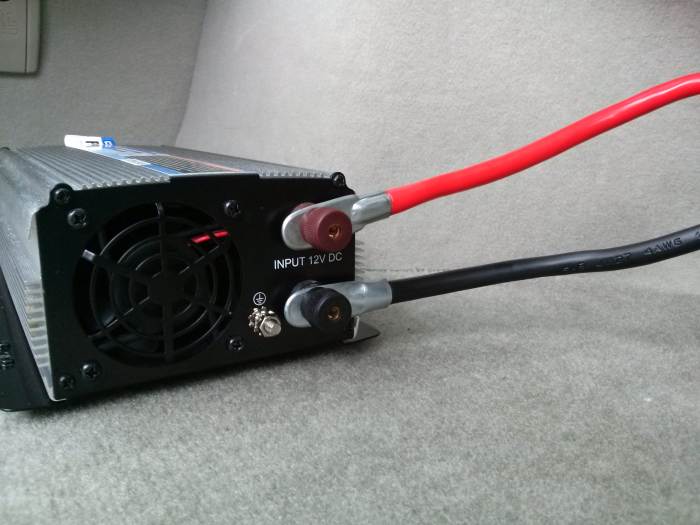 Securely attach the power cables to their appropriate post on the rear of the inverter.