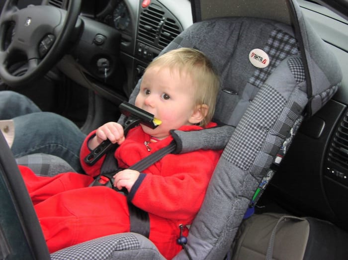Although rear-facing infant car seats are deemed safest, they should NEVER be placed in the front seat of the vehicle!
