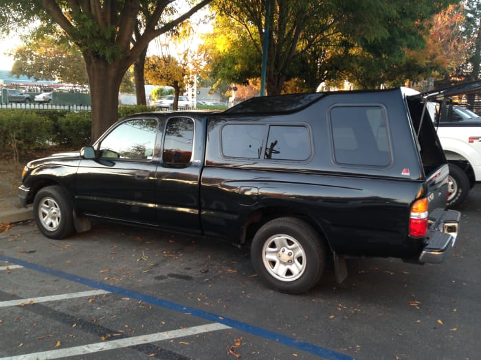 This is a Leer model 122, it's very tall. The side window options are long sliders or a slider and 'bay' window, which is what's pictured here.