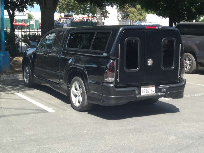 This shell is very unique. This is the SnugTop Outback. The tailgate is fully removed. The shell is still cab level. It offers a variety of other options, like back up camera and roof racks.