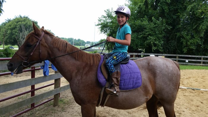 Example of boots that were not purchased in a tack store that work just fine for riding. I will say her feet are too far through the stirrups, though!