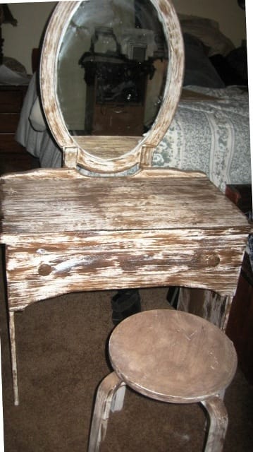Recycled desk, with recycled bathroom vanity mirror. Add a stool and you have a new antique vanity set.