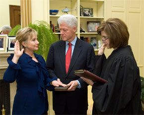 Secretary of State Hillary Clinton, with her husband, being sworn into office, in 2009.