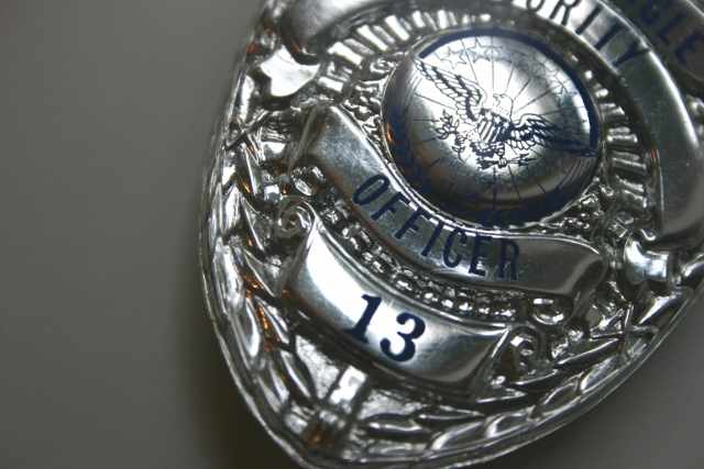 The badge is symbolic of job function and role, identifying the law enforcement officer as legit.